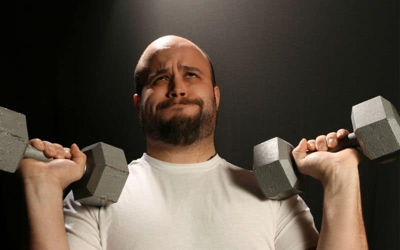 Man struggling to lift weights